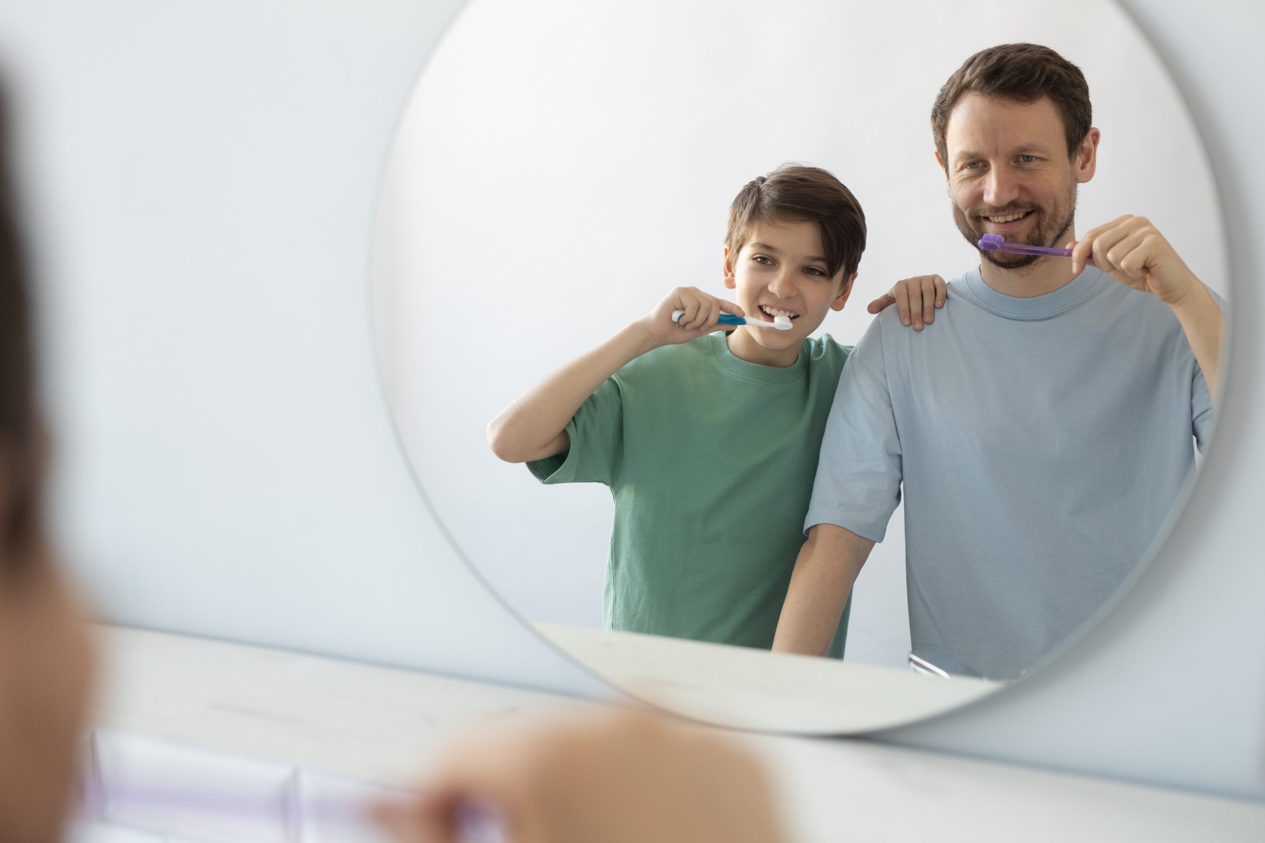 front-view-man-kid-brushing-teeth